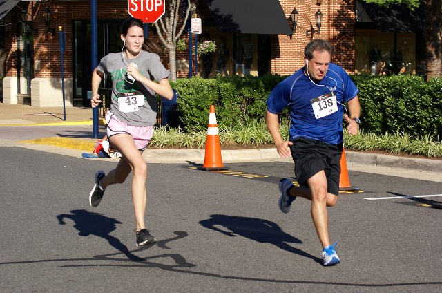 Grace Cleland chases down Chris Rini at the end of the Crime Solvers 5k. Photo: Cheryl Young