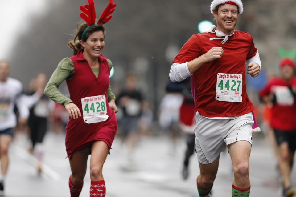 Caroline Paulsen and Ryan Porter maintain solid paces at the Jingle All the Way 8k despite some unorthodox running outfits.                                  Photos by Brian Knight/Swim Bike Run Photography