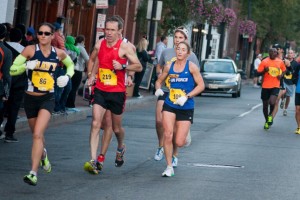 Gina Slaby (Navy) and  Emily Shertzer (Air Force) run together in mile five of the Marine Corps Marathon. Photo: Jimmy Daly