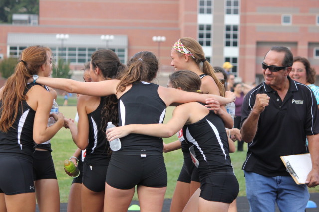 Jim Vollmer celebrates when he learns his Poolesville girls cross country team won the 2013 divisional title. Photo: Melanie 