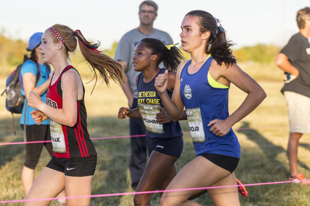 Amanda Swaak, Nora McUmber and Lucy Srour battle through the second mile in the senior girls' race at the DCXC Invitational. Photo: Dustin Whitlow