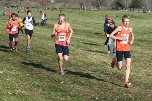 West Springfield's Andrew Lackey drags along teammates Evan Fabish and Nahom Teshome in the final stretch of the 6A boys' race at the Virginia state cross country championships. Photo: Charlie Ban