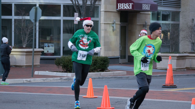 Thomas Foley's (left) idea of getting jolly is kicking to the finish of the Run with Santa. Photo: Cheryl Young