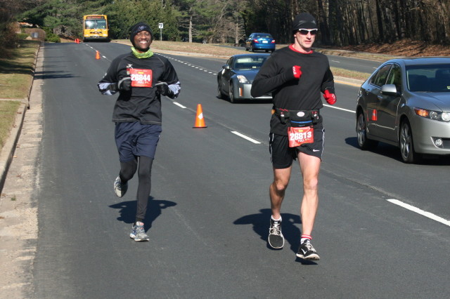 Isaac Mativo is all smiles while Tom Kalka leads the way at mile 15 of the Runners Marathon of Reston. Photo: Charlie Ban