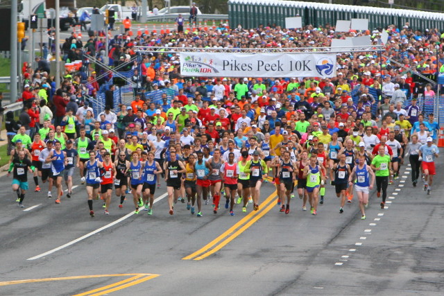 Runners pour out of the Pikes Peek 10k starting line. Photo: Dan and Alex Reichmann