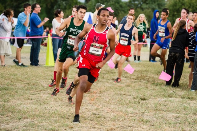 Northwood's Michael Abebe carries his shoe through the senior race. Photo: Marleen Van den Neste