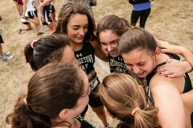 Georgetown Day School's freshmen girls huddle before their race. Photo: Marleen Van den Neste