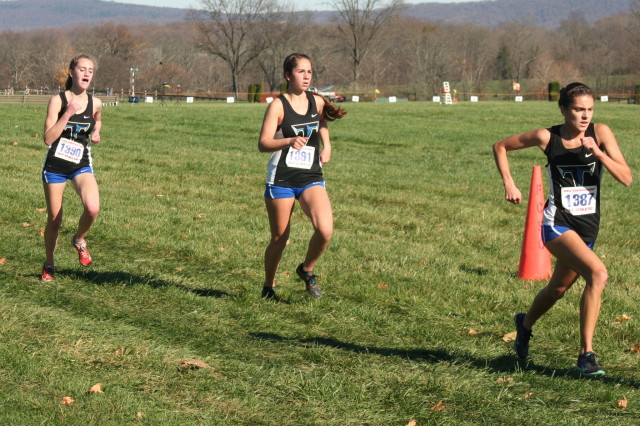 Tuscarora final scorers, and a displacer, for insurance purposed, push the last stretch of the 5A race. Photo: Charlie Ban 