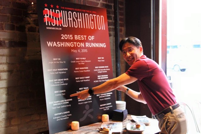 Conroy Zien, 2015's best coach, points to his name on the list of winners at last year's Best of Washington Running party. Photo: Steve Laico