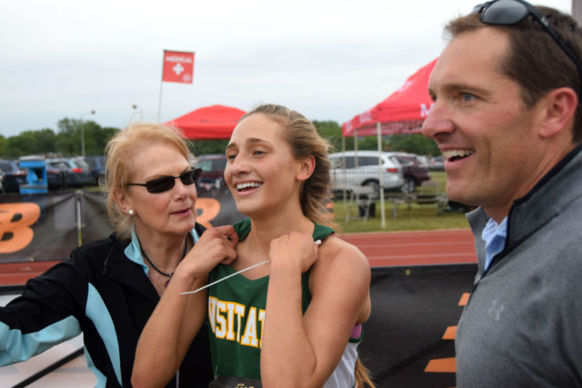 Georgetown Visitation freshman Megan Lynch celebrates her DCXC Invitational race win with her parents. Photo: Charlie Ban