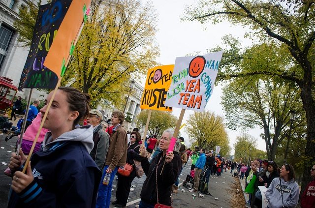 Spectators cheer for family and friends along Jefferson Drive along the National Mall. Photo: Jimmy Daly