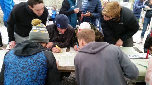 Mike Wardian, lower left, draws his own map from the master course map. Photo: Ed Aramayo 