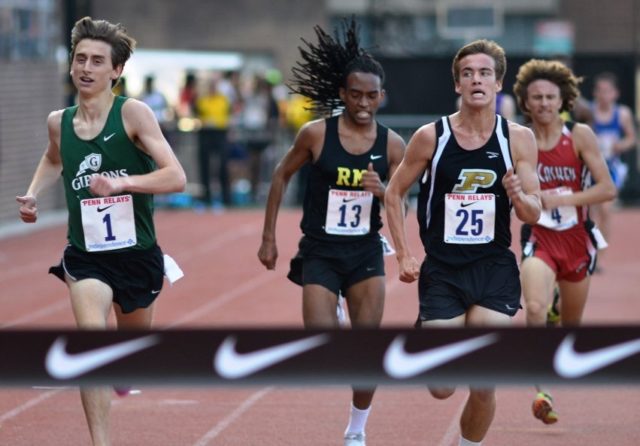 Rohann Asfaw (RM) and Ryan Lockett (Poolesville) close in on the finish line during the 3k at the Penn Relays.