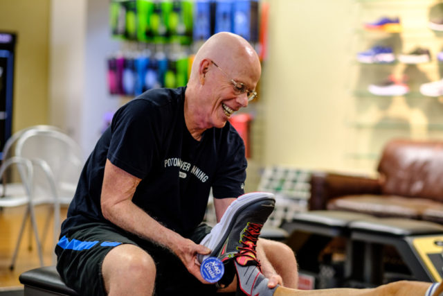 Chris Kelly helps fit a customer during his last shift at 7516 Leesburg Pike before his Potomac River Running store moves to Vienna. RunWashington photo by Dustin Whitlow
