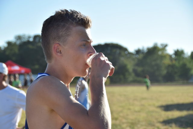 Max Greczyn takes a drink after winning the junior boys' race. Photo: Charlie Ban