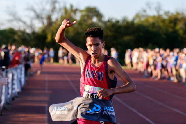 Price Owens breaks the finish line tape to win the senior race at the DCXC Invitational. Photo: Dustin Whitlow/DWhit Photography