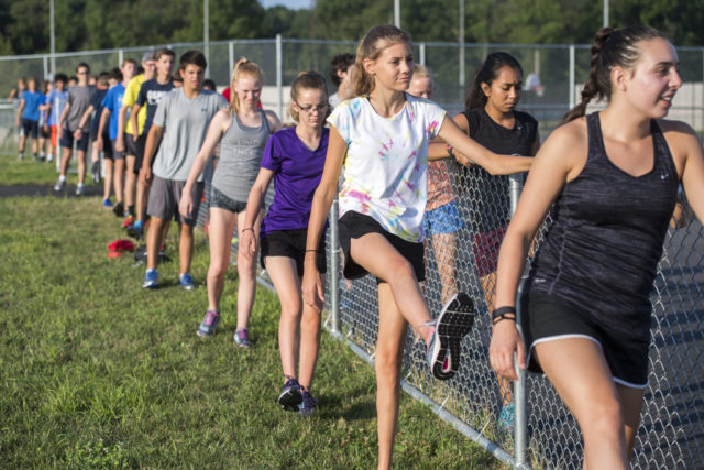 Colgan High School Cross Country runners perform drills before practice. Photo:Doug Stroud 